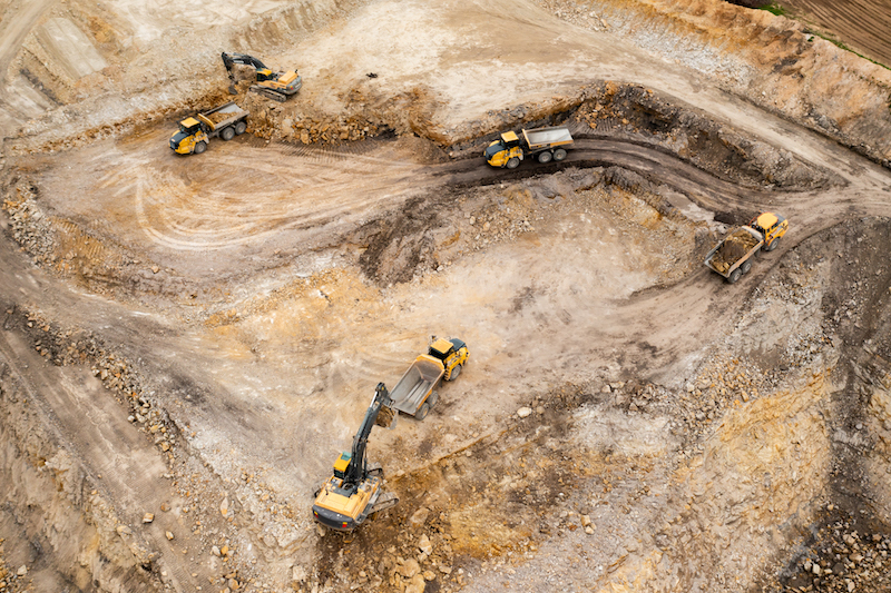 Aerial view of excavators digging ground. Opencast mining quarry