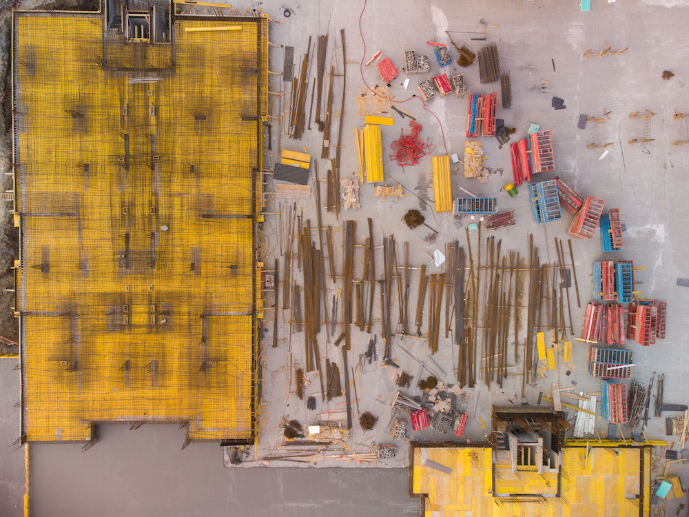 Busy Construction Site and Construction Equipment Aerial top view